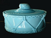 Turquoise glass tobacco jar in form of a drum with a soldiers helmet handle on lid. Probably Davidson