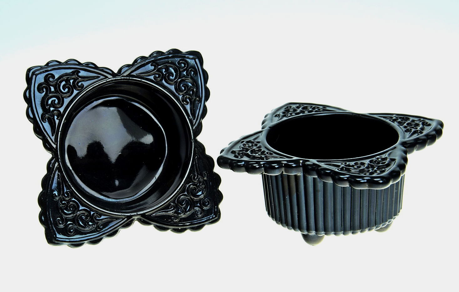 Sowerby jet black, pair of 3 footed salts each with 4 decorated leaves