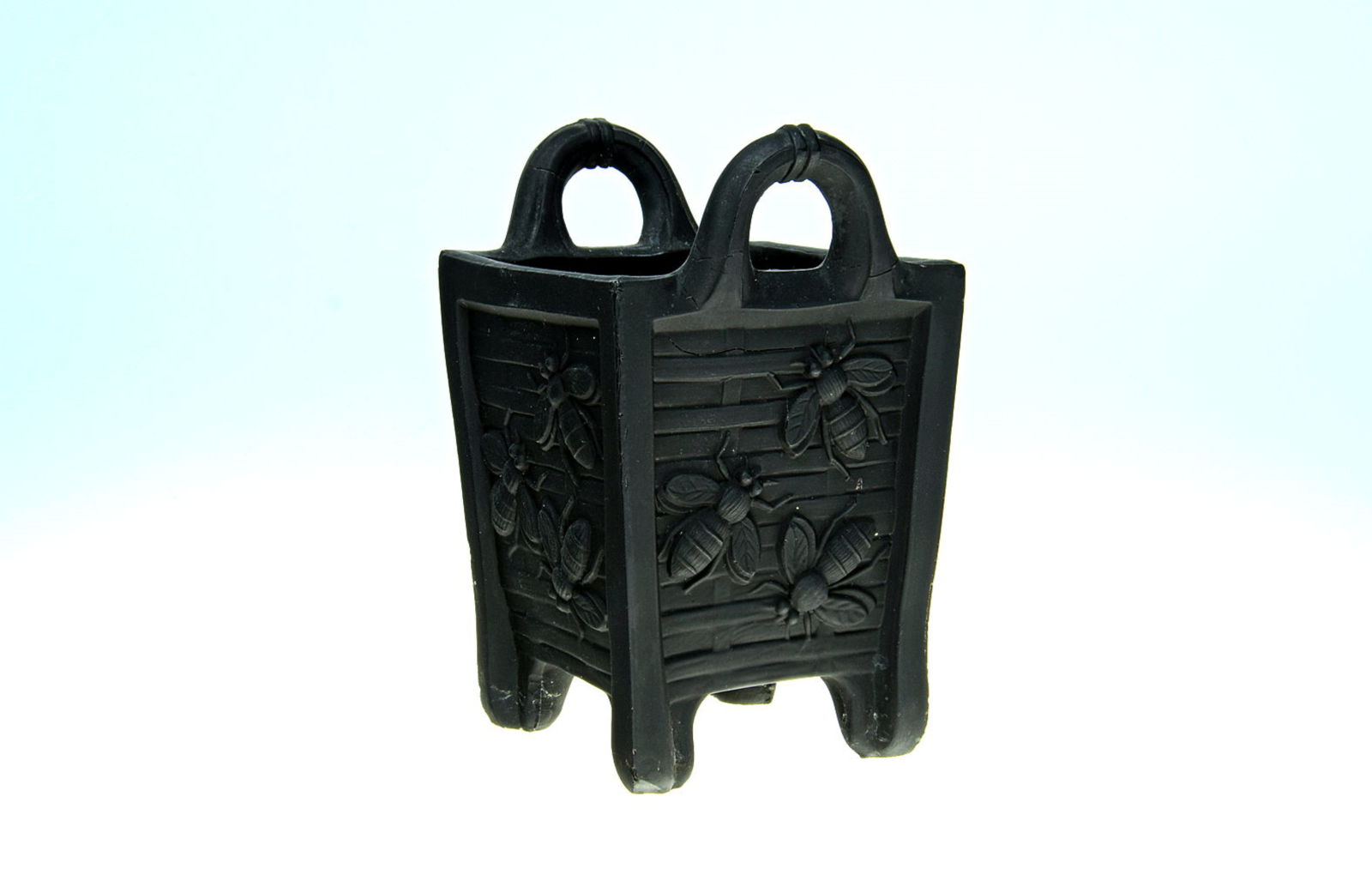 Sowerby jet black, small 4 sided vase with 4 feet, 2 handles, decorated with bees in frosted glass