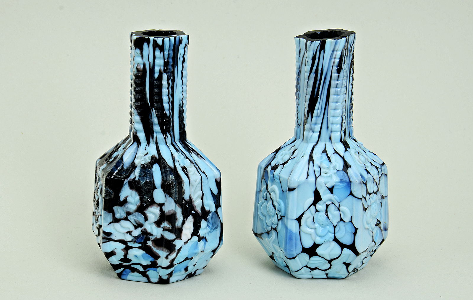 Sowerby marble glass, 2 oriental black bud vases with flower decoration with pale blue marbling