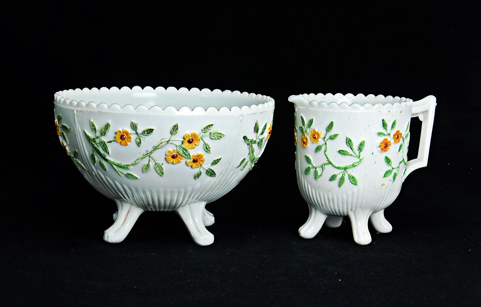 Sowerby opal white, cream jug and sugar bowl decorated with flowers picked out in green and yellow enamel